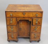 A Georgian walnut kneehole desk. 68 cm wide.