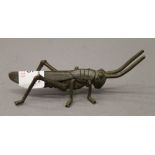 A bronze model of a locust. 11 cm long.