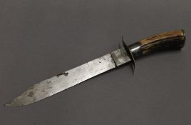 A bowie type hunting knife, with antler handle. 38 cm long.