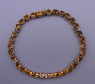 An 18 ct gold diamond and citrine bracelet. 17.5 cm long. 10.7 grammes total weight.