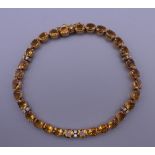 An 18 ct gold diamond and citrine bracelet. 17.5 cm long. 10.7 grammes total weight.