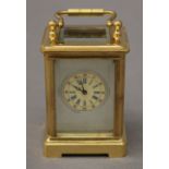 A miniature carriage clock with porcelain panels. 7.5 cm high.