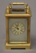 A miniature carriage clock with porcelain panels. 7.5 cm high.