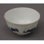 A Chinese porcelain tea bowl decorated with bats. 8 cm diameter.