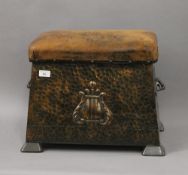 A leather topped beaten copper coal scuttle. 48 cm wide.