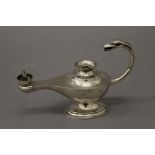 A silver table lighter formed as an oil lamp. 14 cm long. 106.8 grammes total weight.