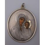 An antique Russian silver clad icon pendant. 8 cm high. 59.6 grammes total weight.