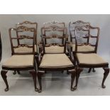 A set of six mahogany ladder back chairs, including two carvers. The carvers 58 cm wide.