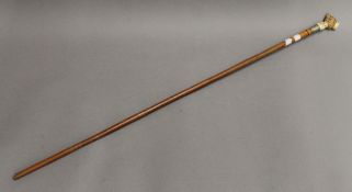 A Victorian walking stick with ivory dog's head handle. 86 cm long.