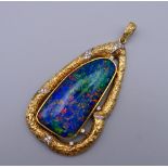 A large 18 K gold opal and diamond pendant. 9 cm high. 70.4 grammes total weight.