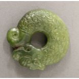 A carved jade roundel. 5 cm diameter.