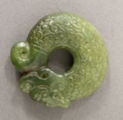 A carved jade roundel. 5 cm diameter.