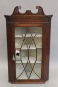 A 19th century mahogany hanging corner cabinet. 121 cm high.