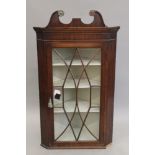 A 19th century mahogany hanging corner cabinet. 121 cm high.