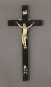 A 19th century carved ivory Christ on ebony cross. 24 cm high.