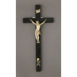 A 19th century carved ivory Christ on ebony cross. 24 cm high.