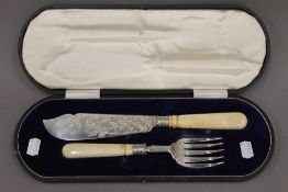 A cased pair of Victorian silver and ivory handled fish servers. 7.5 troy ounces total weight.