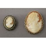 A 9 ct gold mounted cameo brooch and another. The former 4.25 cm high.