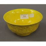 A Chinese porcelain yellow bowl. 15.5 cm diameter.