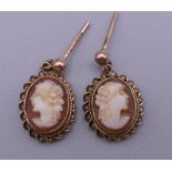 A pair of 9 ct gold and cameo earrings. 1.2 cm high. 1.9 grammes total weight.