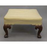 A Georgian style upholstered walnut footstool. 61 cm wide.