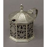 A Georgian silver octagonal engraved and pierced mustard pot with cranberry glass liner. 8 cm high.