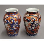 A pair of late 19th century Imari vases. 24 cm high.