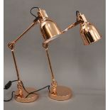A pair of copper anglepoise lamps