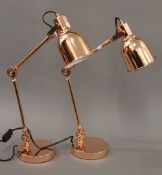 A pair of copper anglepoise lamps