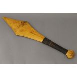A South Seas sword shaped club with hand grip covered with gum.