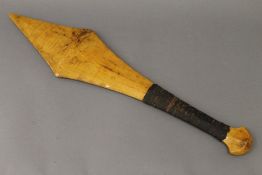 A South Seas sword shaped club with hand grip covered with gum.