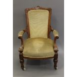 A Victorian upholstered walnut open armchair. 68 cm wide.