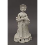 A biscuit figure of a young Queen Victoria, perhaps Derby circa 1840. 28.5 cm high.