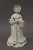 A biscuit figure of a young Queen Victoria, perhaps Derby circa 1840. 28.5 cm high.