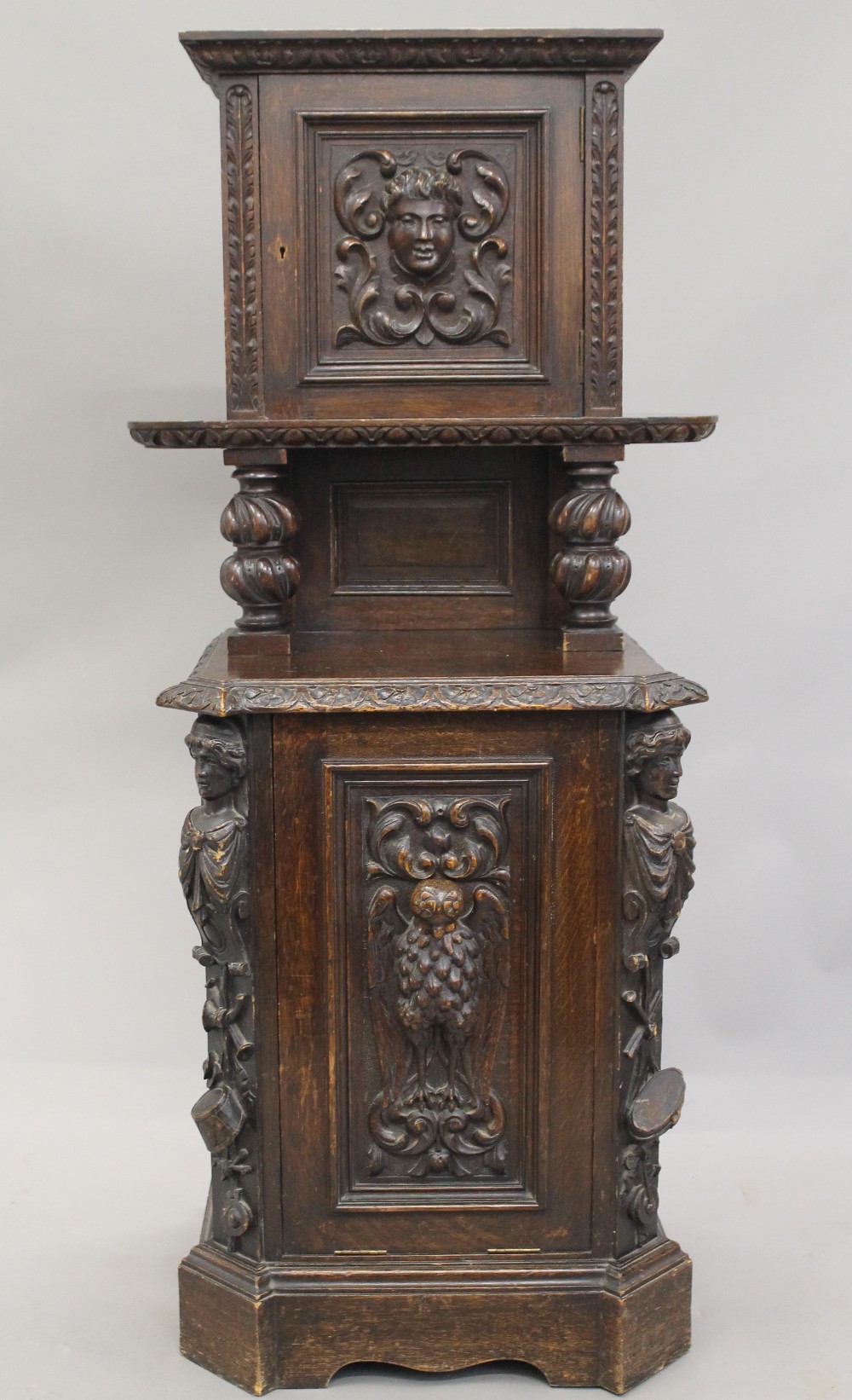 A Victorian carved oak purdonium. 132 cm high.