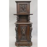 A Victorian carved oak purdonium. 132 cm high.