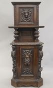 A Victorian carved oak purdonium. 132 cm high.