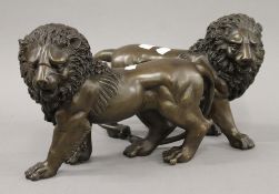 A pair of bronze lions. 31 cm long.