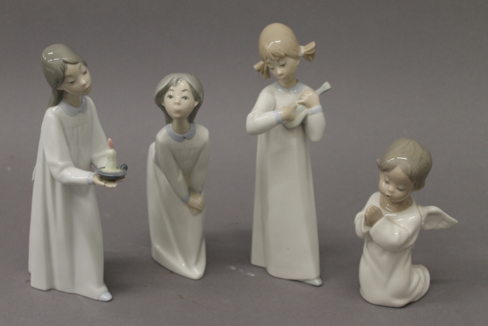 Four Lladro figurines. The largest 20 cm high.