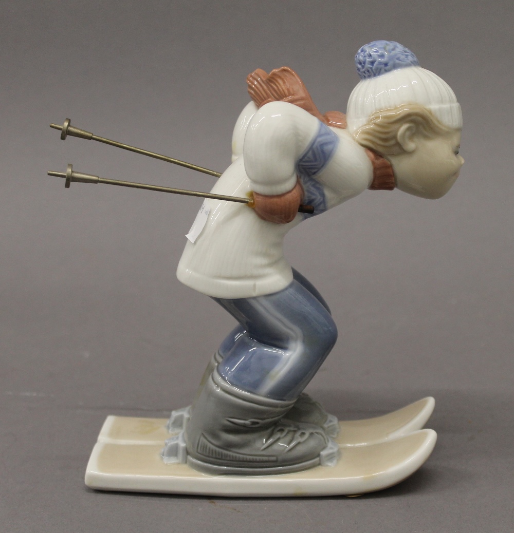 A Lladro figure of a skiing boy. 17.5 cm high. - Image 2 of 3