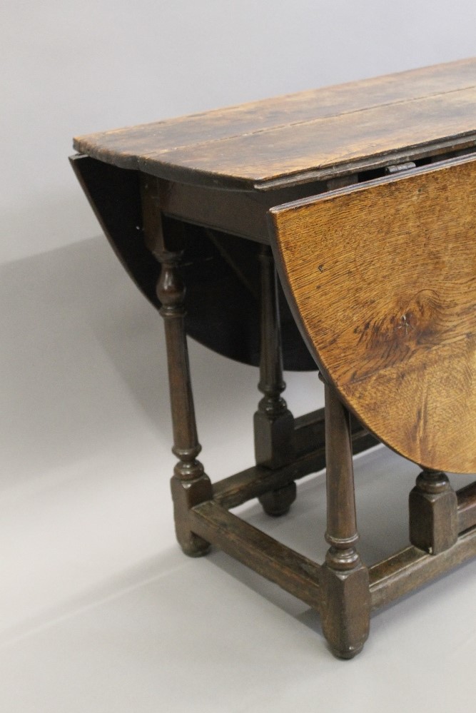 An 18th century oak drop leaf table. 111 cm wide. - Image 3 of 3