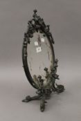 A Rococo style bronzed cast metal dressing table mirror. 44 cm high.