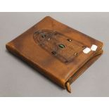 A leather stationary wallet. 25 cm high.