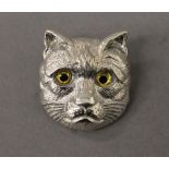 A silver cat brooch. 3 cm high.