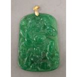 A gold mounted jade pendant. 5.5 cm high.