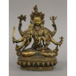 A gilt bronze model of a multi-armed deity set with cabochon. 21.5 cm high.