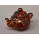 A small model teapot. 7 cm wide.