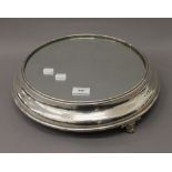 A silver plated mirrored cake stand. 38 cm diameter overall.