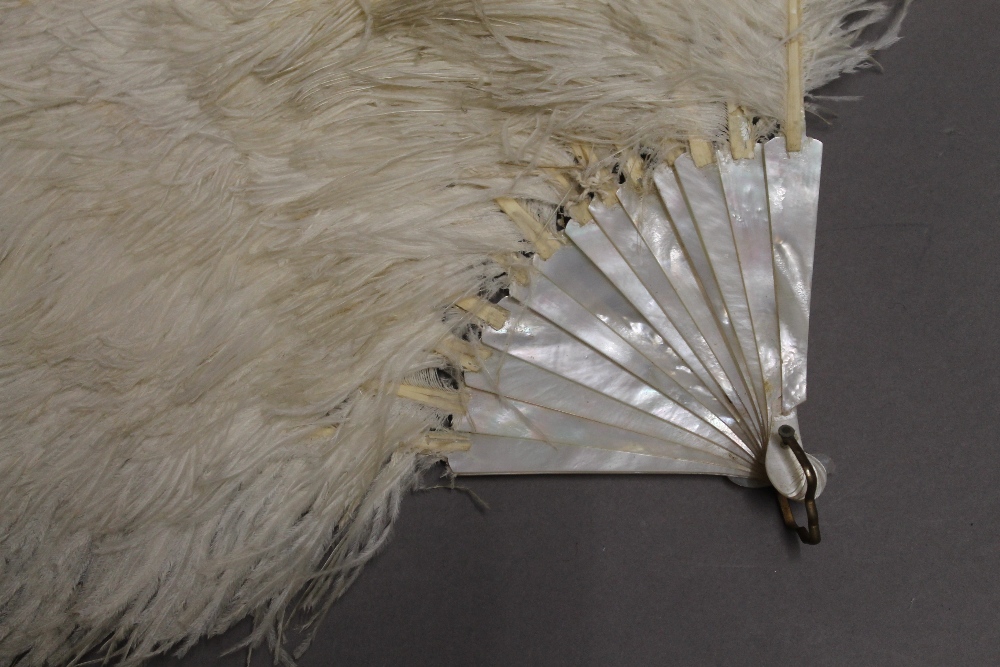 A vintage ostrich feather and mother-of-pearl fan. 38 cm long. - Image 2 of 2