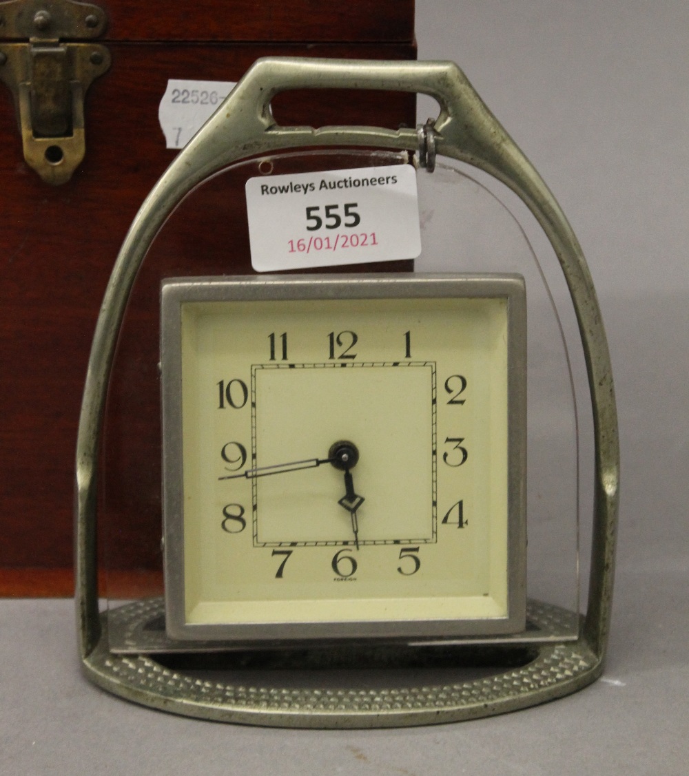 A stirrup form clock in a wooden box. The clock 14 cm high. - Image 2 of 3